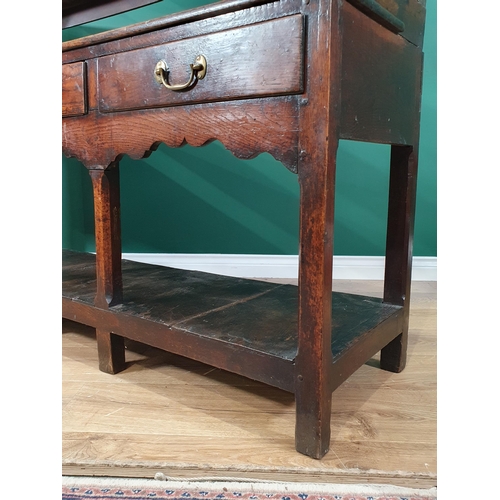 423 - An 18th Century Welsh oak Pot board Dresser and Rack the base fitted three drawers above Cupid's bow... 