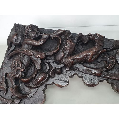 426 - A pair of 17th Century Spandrels carved with Fawns, winged Dolphin, Dog and mythical Beast amongst l... 