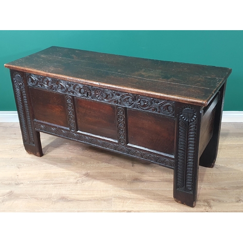 430 - An antique oak Coffer with carved and panelled front and stylised floral carving to the front suppor... 