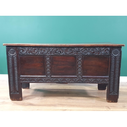 430 - An antique oak Coffer with carved and panelled front and stylised floral carving to the front suppor... 