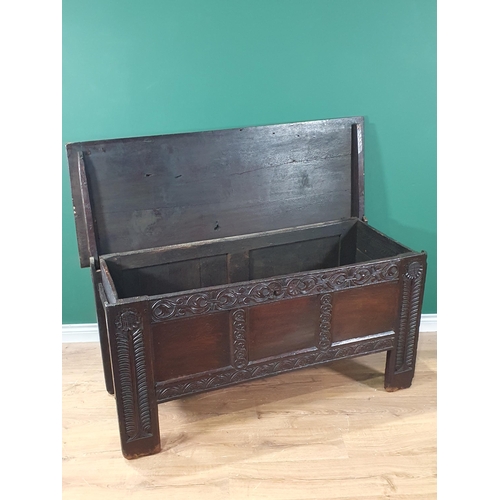 430 - An antique oak Coffer with carved and panelled front and stylised floral carving to the front suppor... 