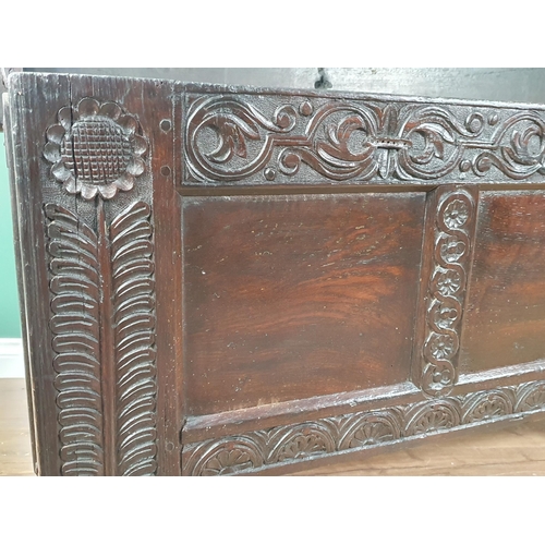 430 - An antique oak Coffer with carved and panelled front and stylised floral carving to the front suppor... 