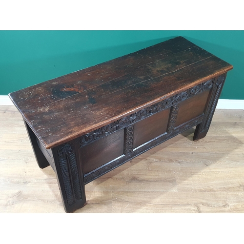 430 - An antique oak Coffer with carved and panelled front and stylised floral carving to the front suppor... 