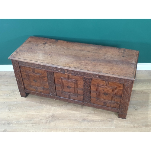 431 - An antique oak Coffer with plank lid above rosette frieze and carved three panel front, 4ft