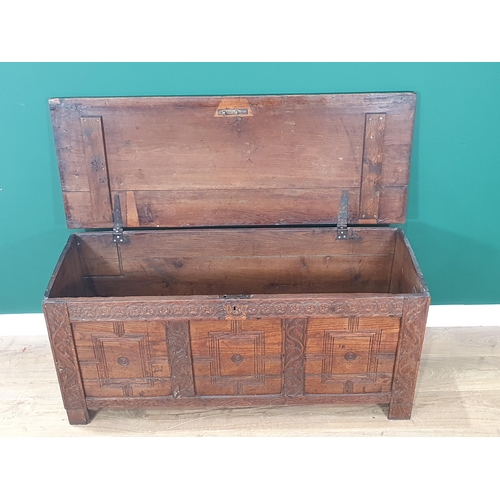 431 - An antique oak Coffer with plank lid above rosette frieze and carved three panel front, 4ft