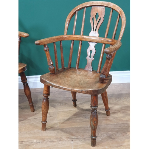 432 - A pair of 19th Century ash child's Windsor Chairs with pierced splat backs raised on turned supports... 