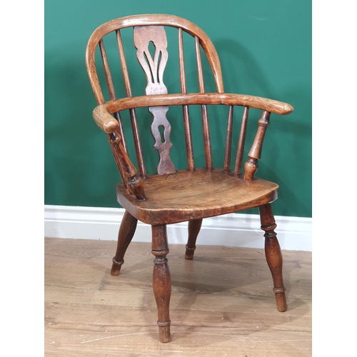 432 - A pair of 19th Century ash child's Windsor Chairs with pierced splat backs raised on turned supports... 