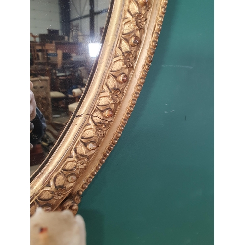 433 - A late 19th Century oval giltwood and plaster Girandole Mirror with pierced and foliate scrolled sur... 