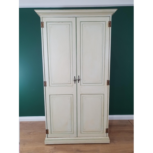 445 - A pale green painted Wardrobe with pair of full length panelled doors, 3ft 6in