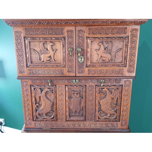 450 - A Victorian carved oak Secretaire Cabinet with pair of doors enclosing small cupboard above fall fro... 