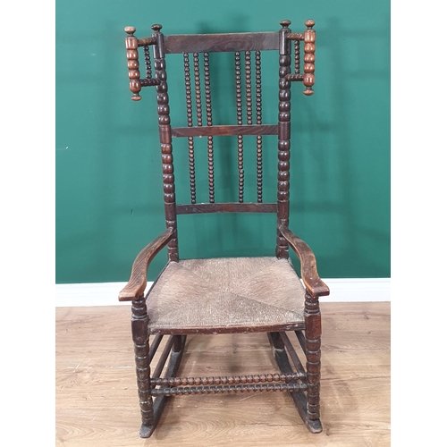 471 - A bobbin-turned Rocking Chair in the manner of Ernest Gimson, with bobbin wingback, spindle back, ru... 