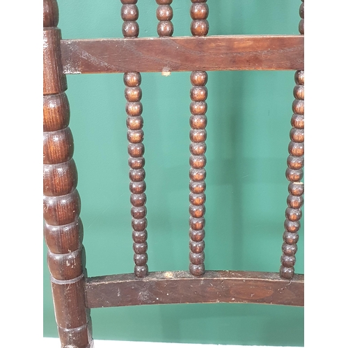 471 - A bobbin-turned Rocking Chair in the manner of Ernest Gimson, with bobbin wingback, spindle back, ru... 