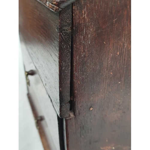 475 - An 18th Century Welsh oak Candle Box with pierced heart shaped hanger, above lift-up lid, with two f... 