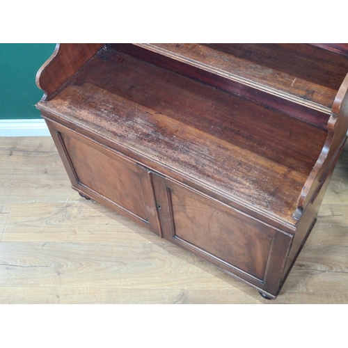 478 - A 19th Century mahogany Waterfall Bookcase, the shelves with shaped supports, above pair of panelled... 