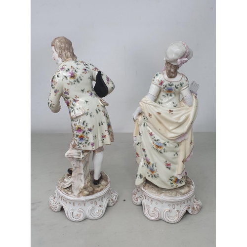 542 - A pair of continental Figures of a gentleman and lady dressed in matching floral and gilt roses and ... 