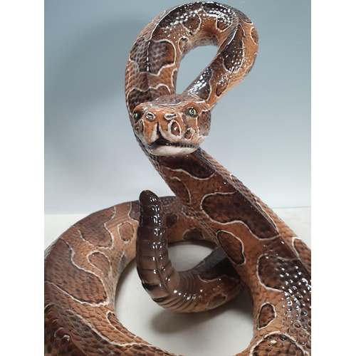 543 - An Italian large ceramic coiled Snake with brown painted details,15in