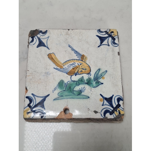 549 - A collection of nine antique delft Tiles, three depicting birds with coloured highlight decoration (... 