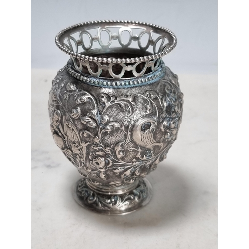 55 - A Continental silver baluster vase embossed figures, birds and flowers, pierced rim, 3 1/2in