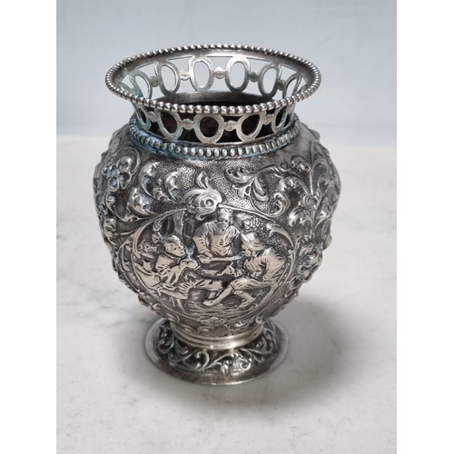 55 - A Continental silver baluster vase embossed figures, birds and flowers, pierced rim, 3 1/2in