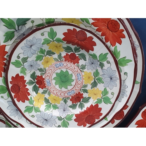 553 - A 19th Century creamware part Dinner Service with over-glaze painted floral design in predominantly ... 