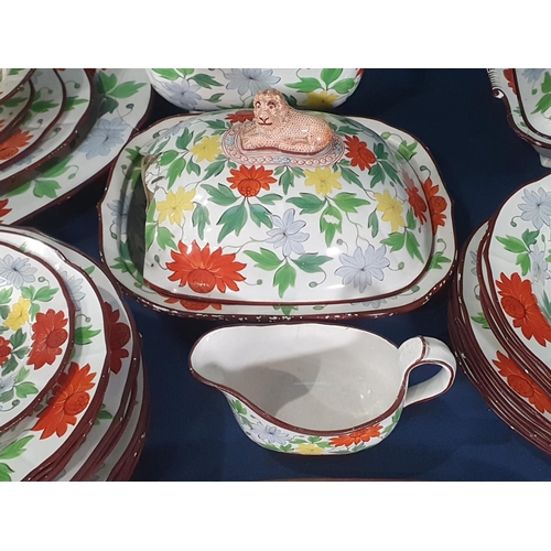 553 - A 19th Century creamware part Dinner Service with over-glaze painted floral design in predominantly ... 