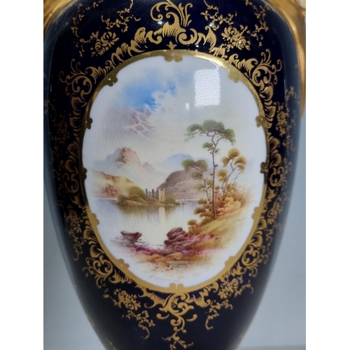 556 - A Coalport baluster Vase and Cover with two handles, having swag decoration, painted scene of Kilchu... 