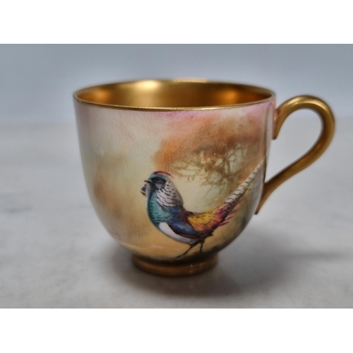 571 - A Royal Worcester Coffee Cup and Saucer painted Asiatic pheasant in landscape