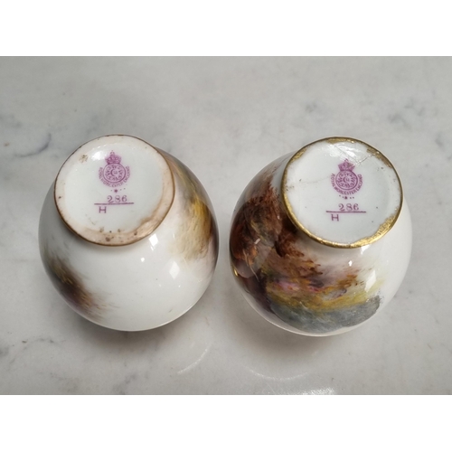 573 - A small pair of Royal Worcester baluster Vases painted scenes of highland cattle in landscapes, sign... 