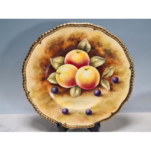 579 - A large Coalport Fruit Bowl, painted fruit by N.Lear, 10 1/2in D, on three feet, and a Plate with sh... 