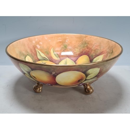 579 - A large Coalport Fruit Bowl, painted fruit by N.Lear, 10 1/2in D, on three feet, and a Plate with sh... 