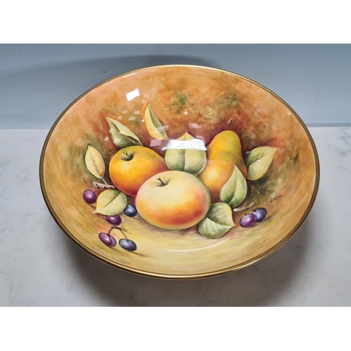 579 - A large Coalport Fruit Bowl, painted fruit by N.Lear, 10 1/2in D, on three feet, and a Plate with sh... 