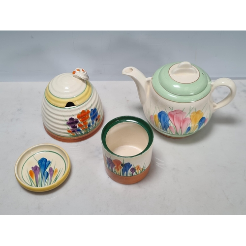 583 - A Clarice Cliff lidded Honey Pot, Teapot, small Trinket Dish and Jam Pot, (missing lid), all 'Crocus... 