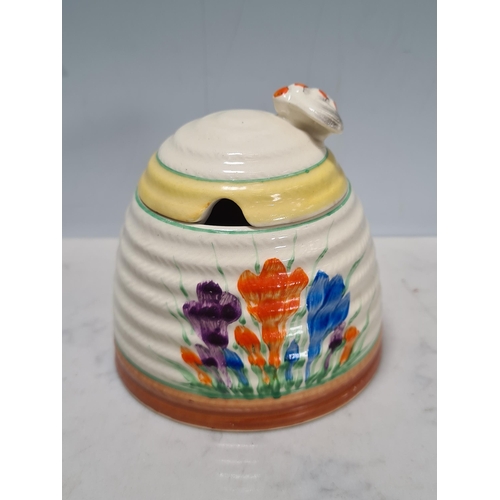 583 - A Clarice Cliff lidded Honey Pot, Teapot, small Trinket Dish and Jam Pot, (missing lid), all 'Crocus... 