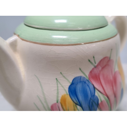 583 - A Clarice Cliff lidded Honey Pot, Teapot, small Trinket Dish and Jam Pot, (missing lid), all 'Crocus... 