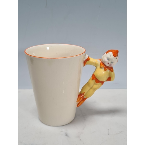 585 - A Clarice Cliff novelty Chick Cocoa Pot and a tapering cylindrical Mug with figure of a boy as handl... 