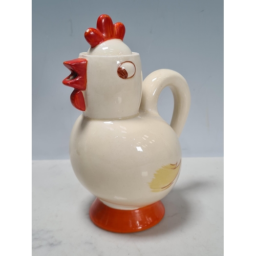 585 - A Clarice Cliff novelty Chick Cocoa Pot and a tapering cylindrical Mug with figure of a boy as handl... 