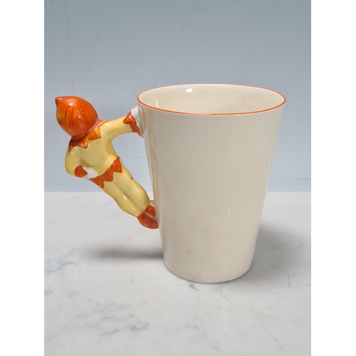 585 - A Clarice Cliff novelty Chick Cocoa Pot and a tapering cylindrical Mug with figure of a boy as handl... 