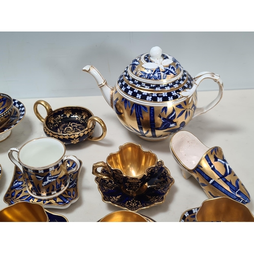 586 - A collection of Coalport miniature Coffee Pots, Saucers, Dishes, Bowls and Vases, chiefly blue and g... 