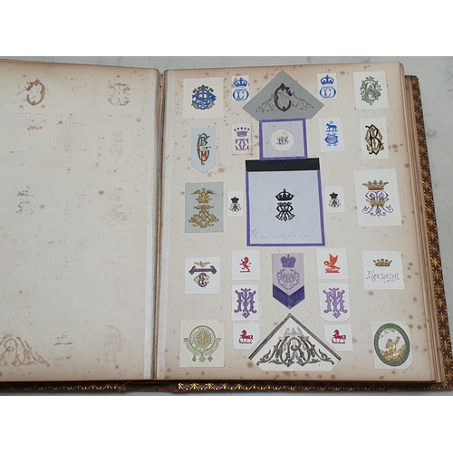 635 - Two gilt tooled leather Albums containing a collection of Coats of Arms.