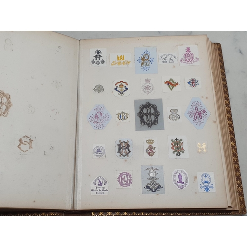 635 - Two gilt tooled leather Albums containing a collection of Coats of Arms.