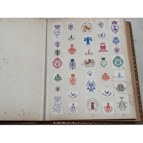 635 - Two gilt tooled leather Albums containing a collection of Coats of Arms.