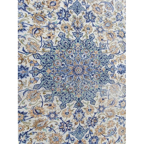 653 - A bordered Persian Carpet with central floral medallion in blue and green, palmette and floral scrol... 