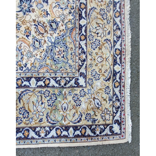 653 - A bordered Persian Carpet with central floral medallion in blue and green, palmette and floral scrol... 