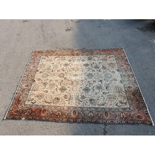 654 - A bordered Persian Carpet with palmette and scroll design on cream ground, the main border with palm... 