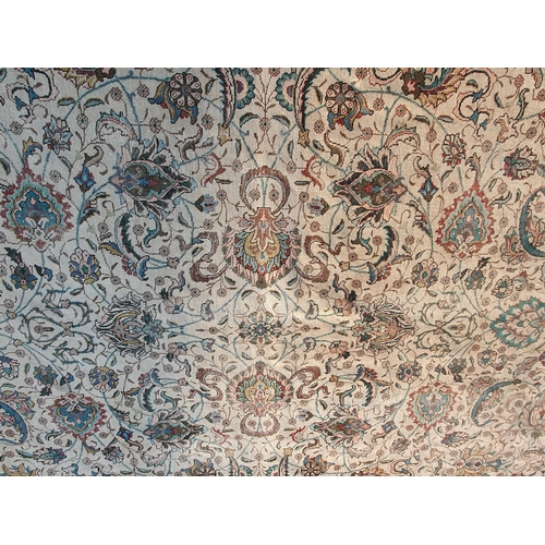 654 - A bordered Persian Carpet with palmette and scroll design on cream ground, the main border with palm... 