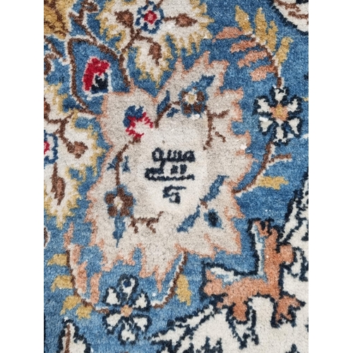 656 - A Kashan Carpet with central oval floral medallion surrounded by foliate designs, the border with de... 