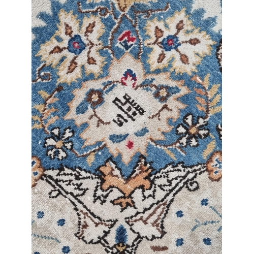 656 - A Kashan Carpet with central oval floral medallion surrounded by foliate designs, the border with de... 