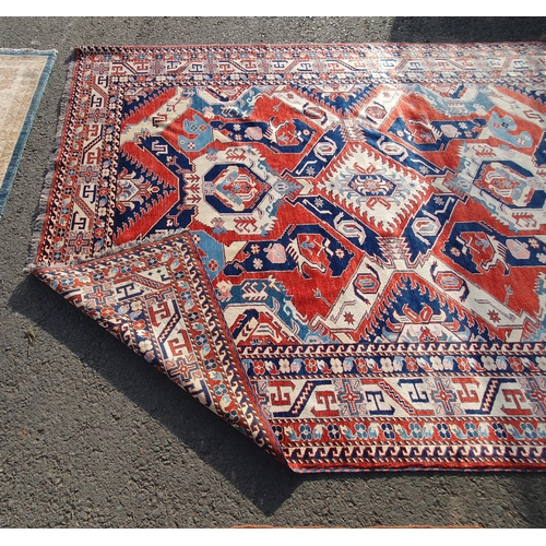 658 - A bordered Kazak type Carpet, the central field with boteh and palmettes in blue, red and cream, the... 