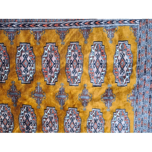 661 - A Turkmen style multi bordered Carpet having five rows of guls on a ochre coloured ground, 11ft 8