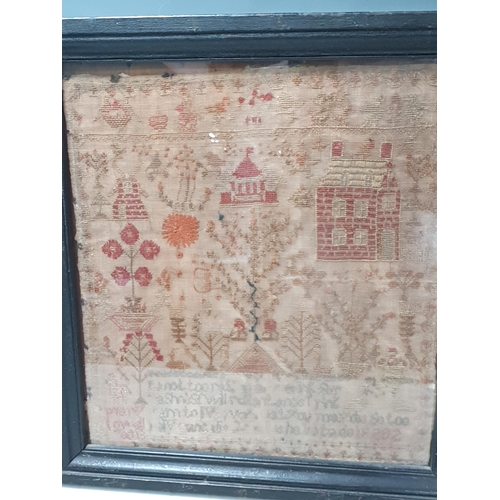 675 - A 19th Century needlework Sampler with decoration of flowers, trees and buildings above indistinct v... 